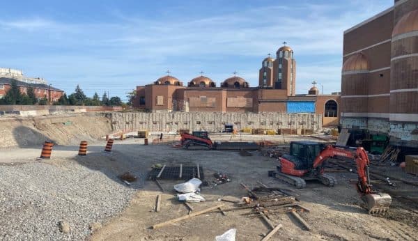Excavation site with equipment near church at 935 Eglinton Avenue West geostructural project.